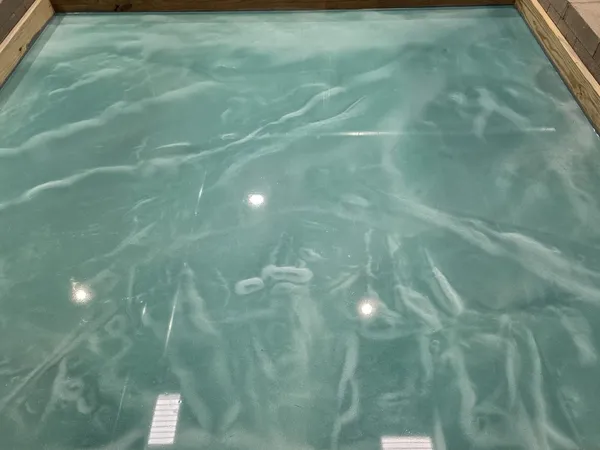 Space with polished metallic epoxy flooring